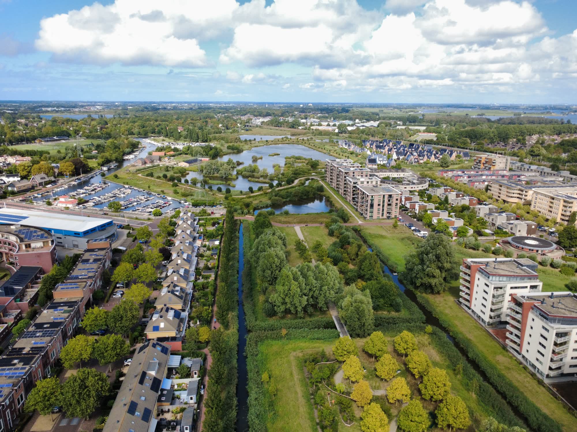 Luchtfoto van een woonwijk met park en water